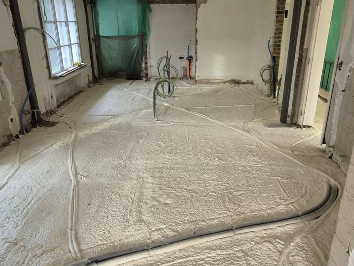 Gespoten PUR-isolatie op een vloer tijdens renovatie